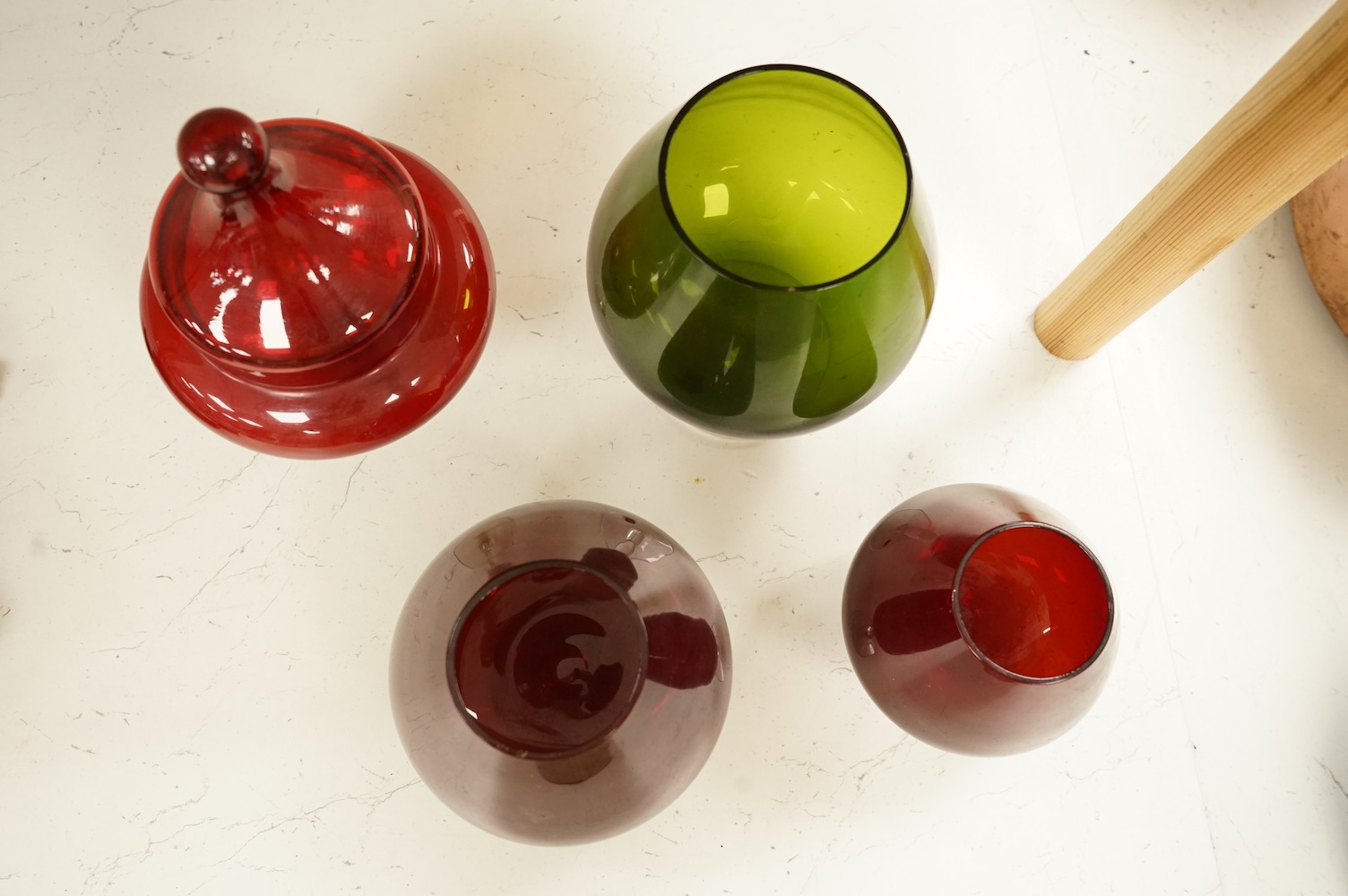Five pieces of glassware to include a Swedish oversized brandy balloon, red glass sweetmeat dish and cover and a vase, largest 28cm high